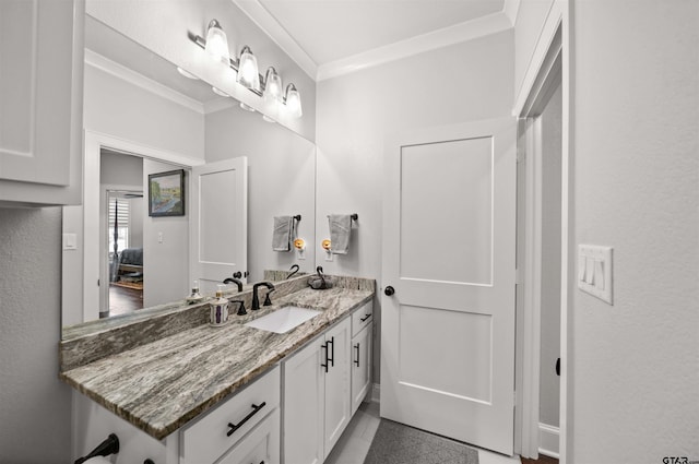 bathroom featuring ornamental molding and vanity