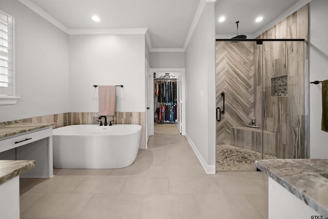 bathroom with crown molding, vanity, plus walk in shower, and tile patterned flooring