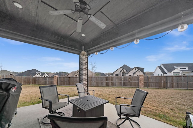 view of patio with ceiling fan, a grill, and an outdoor fire pit