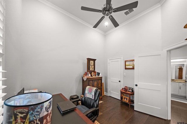 home office with ceiling fan, ornamental molding, dark hardwood / wood-style floors, and a towering ceiling