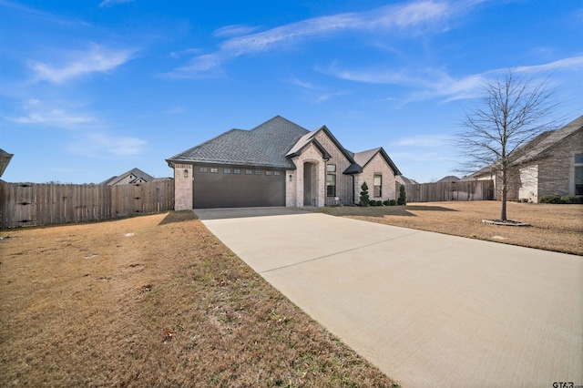 view of front facade featuring a garage and a front lawn