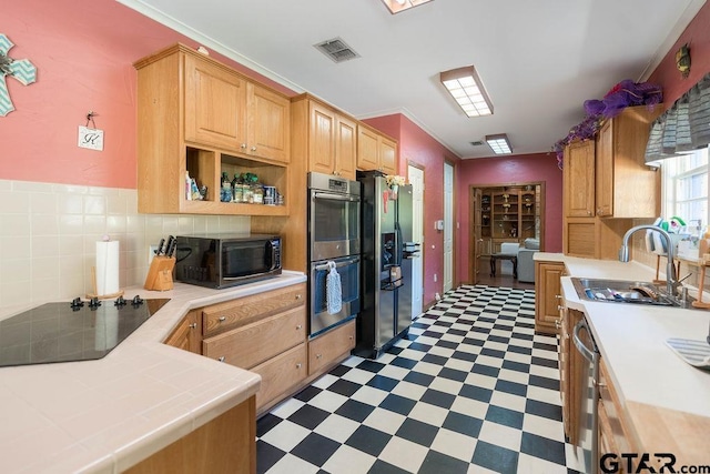 1017 Hilltop Dr, Palestine, TX 75801 - kitchen featuring a sink, stainless steel appliances, tile countertops, light floors, and ornamental molding