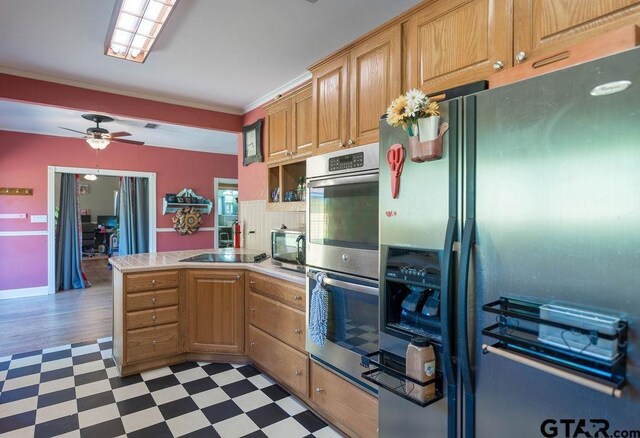 1017 Hilltop Dr, Palestine, TX 75801 - kitchen with stainless steel appliances, a ceiling fan, a peninsula, light floors, and ornamental molding