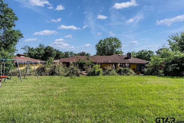 1017 Hilltop Dr, Palestine, TX 75801 - exterior space with a playground, a chimney, and a lawn