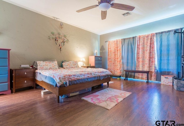 1017 Hilltop Dr, Palestine, TX 75801 - bedroom with crown molding, a ceiling fan, visible vents, and wood finished floors