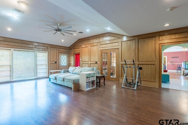 1017 Hilltop Dr, Palestine, TX 75801 - living room with ceiling fan, wood walls, wood finished floors, lofted ceiling, and visible vents