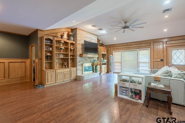 1017 Hilltop Dr, Palestine, TX 75801 - living area with ceiling fan, visible vents, a fireplace, vaulted ceiling, and wood finished floors