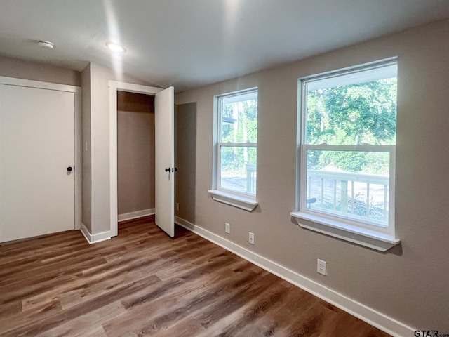 unfurnished bedroom with hardwood / wood-style flooring and a closet