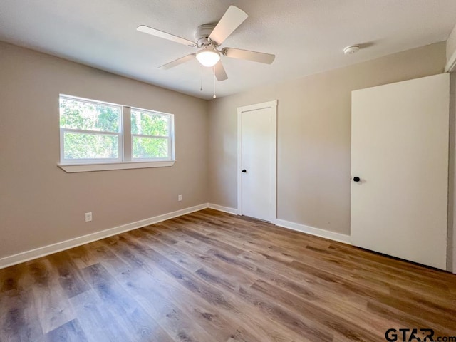 unfurnished bedroom with wood-type flooring and ceiling fan