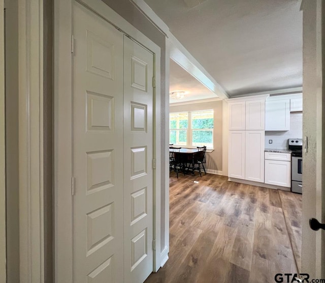 corridor with light hardwood / wood-style flooring