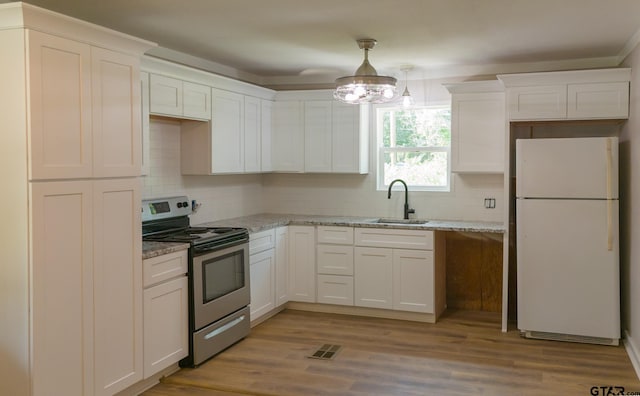 kitchen featuring white cabinetry, white fridge, sink, and electric range