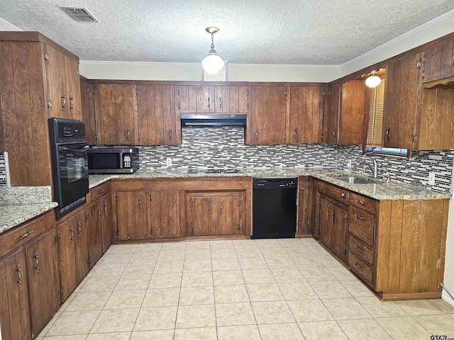 kitchen featuring hanging light fixtures, light stone counters, backsplash, a textured ceiling, and black appliances