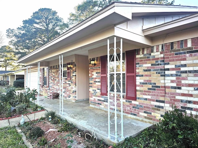 view of exterior entry with a porch