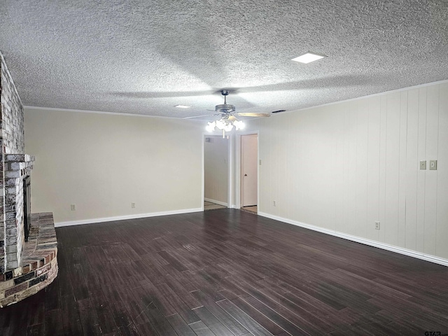 unfurnished living room featuring dark hardwood / wood-style floors, ceiling fan, a textured ceiling, and a brick fireplace