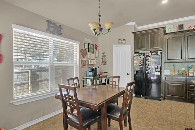 dining room featuring ornamental molding and an inviting chandelier