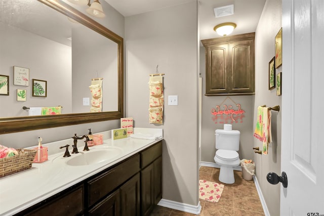 bathroom featuring tile patterned floors, vanity, and toilet