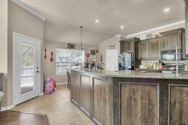 kitchen with pendant lighting, electric range, light stone countertops, refrigerator with ice dispenser, and dark brown cabinetry