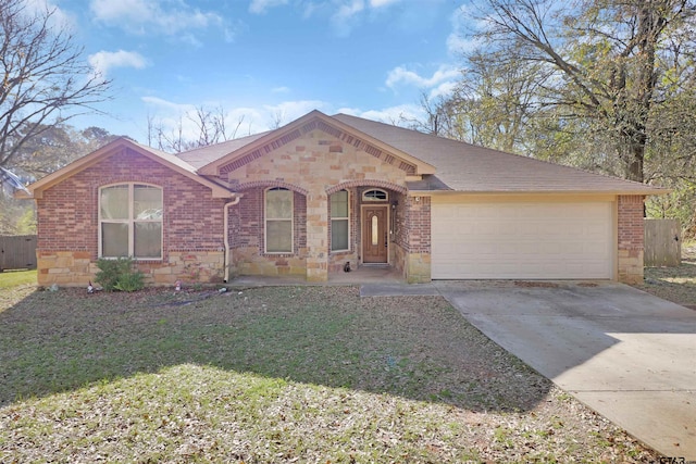 ranch-style home with a garage and a front lawn