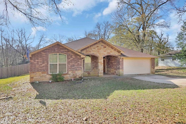 ranch-style house featuring a garage and a front yard