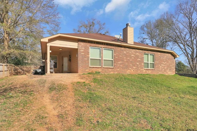 back of house with a yard