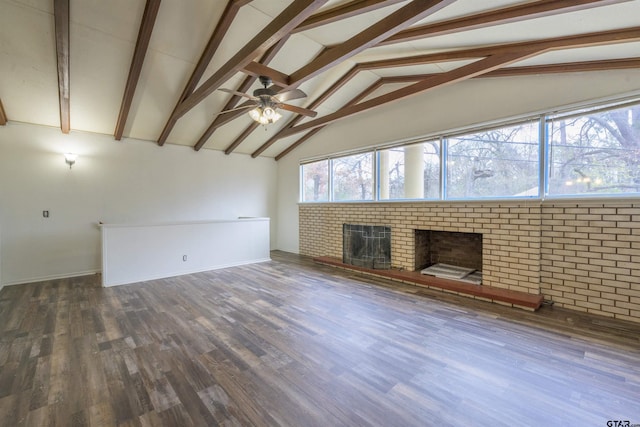 unfurnished living room featuring high vaulted ceiling, a brick fireplace, dark hardwood / wood-style floors, beamed ceiling, and ceiling fan