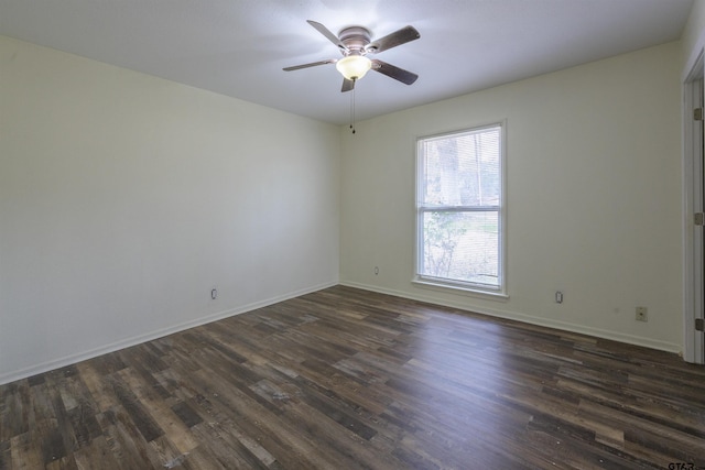 spare room with dark hardwood / wood-style floors and ceiling fan