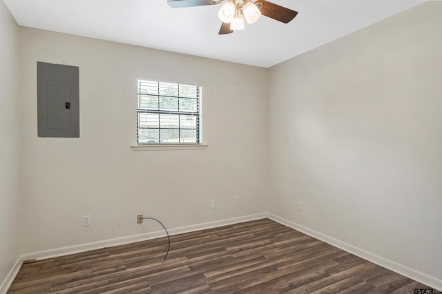 empty room with electric panel, ceiling fan, and dark wood-type flooring