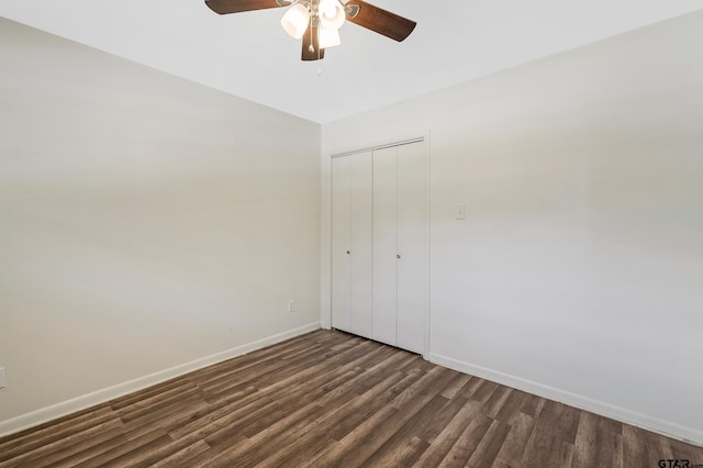 unfurnished bedroom with ceiling fan, a closet, and dark hardwood / wood-style flooring