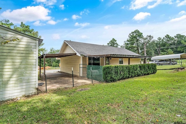 view of property exterior with a yard and a carport