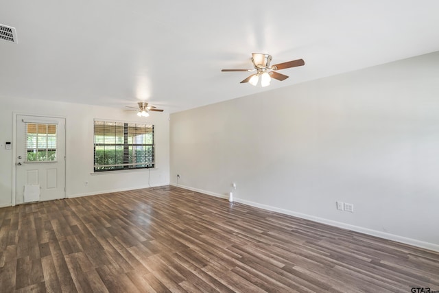 unfurnished living room featuring dark wood-type flooring and ceiling fan