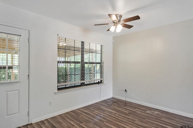 spare room with dark hardwood / wood-style flooring and ceiling fan