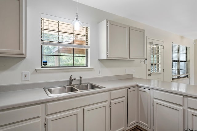 kitchen featuring pendant lighting, a wealth of natural light, and sink