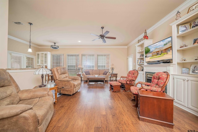 2215 Homestead Ln, Tyler, TX 75701 - living room with ornamental molding, light wood-style floors, visible vents, and ceiling fan