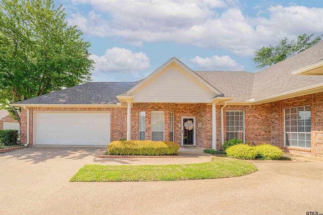 2215 Homestead Ln, Tyler, TX 75701 - ranch-style home featuring concrete driveway, brick siding, roof with shingles, and a garage