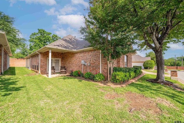 2215 Homestead Ln, Tyler, TX 75701 - back of house with fence, a patio, brick siding, and a lawn