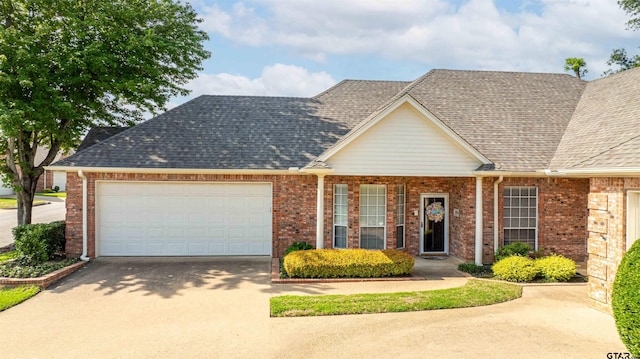 2215 Homestead Ln, Tyler, TX 75701 - view of front of house with a shingled roof, brick siding, driveway, and a garage