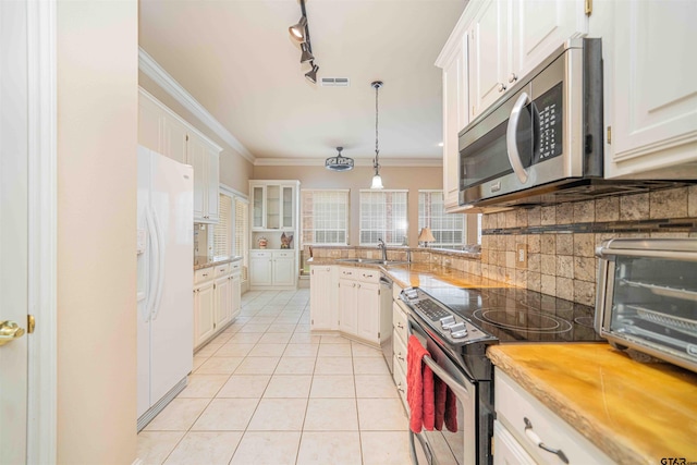 2215 Homestead Ln, Tyler, TX 75701 - kitchen featuring a sink, visible vents, crown molding, white cabinetry, and appliances with stainless steel finishes