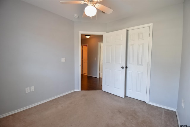 unfurnished bedroom with a closet, ceiling fan, and carpet