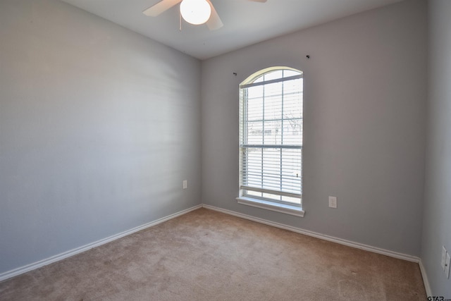 carpeted empty room featuring ceiling fan