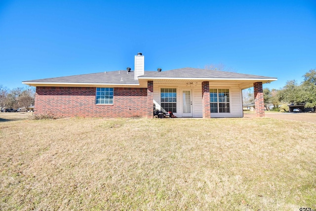 back of house with a lawn