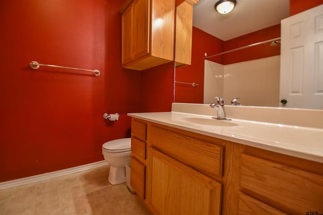 bathroom featuring vanity, a shower, and toilet