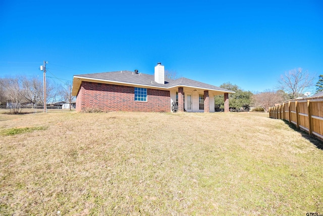 back of house featuring a lawn