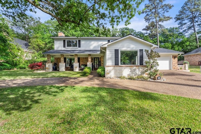 view of front of home featuring a front lawn, a porch, and a garage