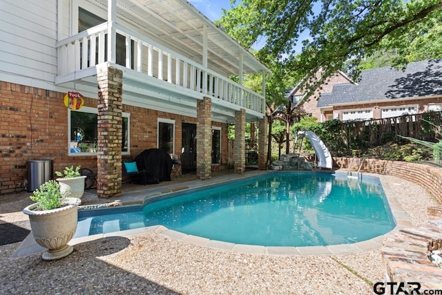 view of pool with a grill, a patio area, and a water slide