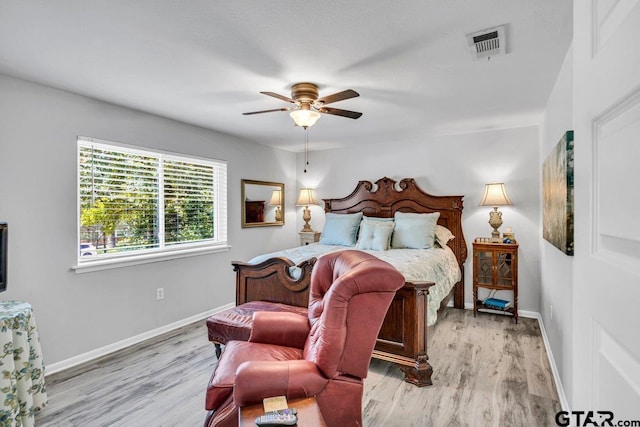 bedroom with light hardwood / wood-style flooring and ceiling fan