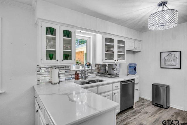 kitchen with light stone countertops, sink, pendant lighting, dishwasher, and white cabinetry