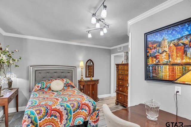 bedroom with ornamental molding and a textured ceiling