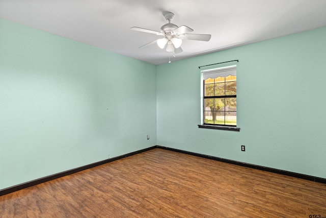 spare room with hardwood / wood-style floors and ceiling fan