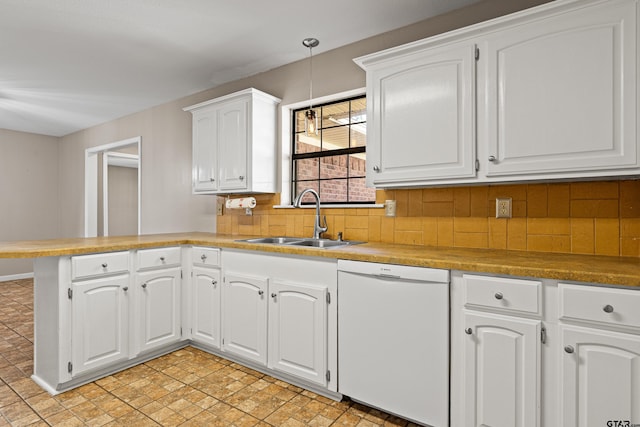 kitchen with sink, white cabinetry, dishwasher, kitchen peninsula, and decorative backsplash