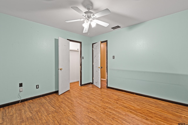 unfurnished room with ceiling fan and light wood-type flooring